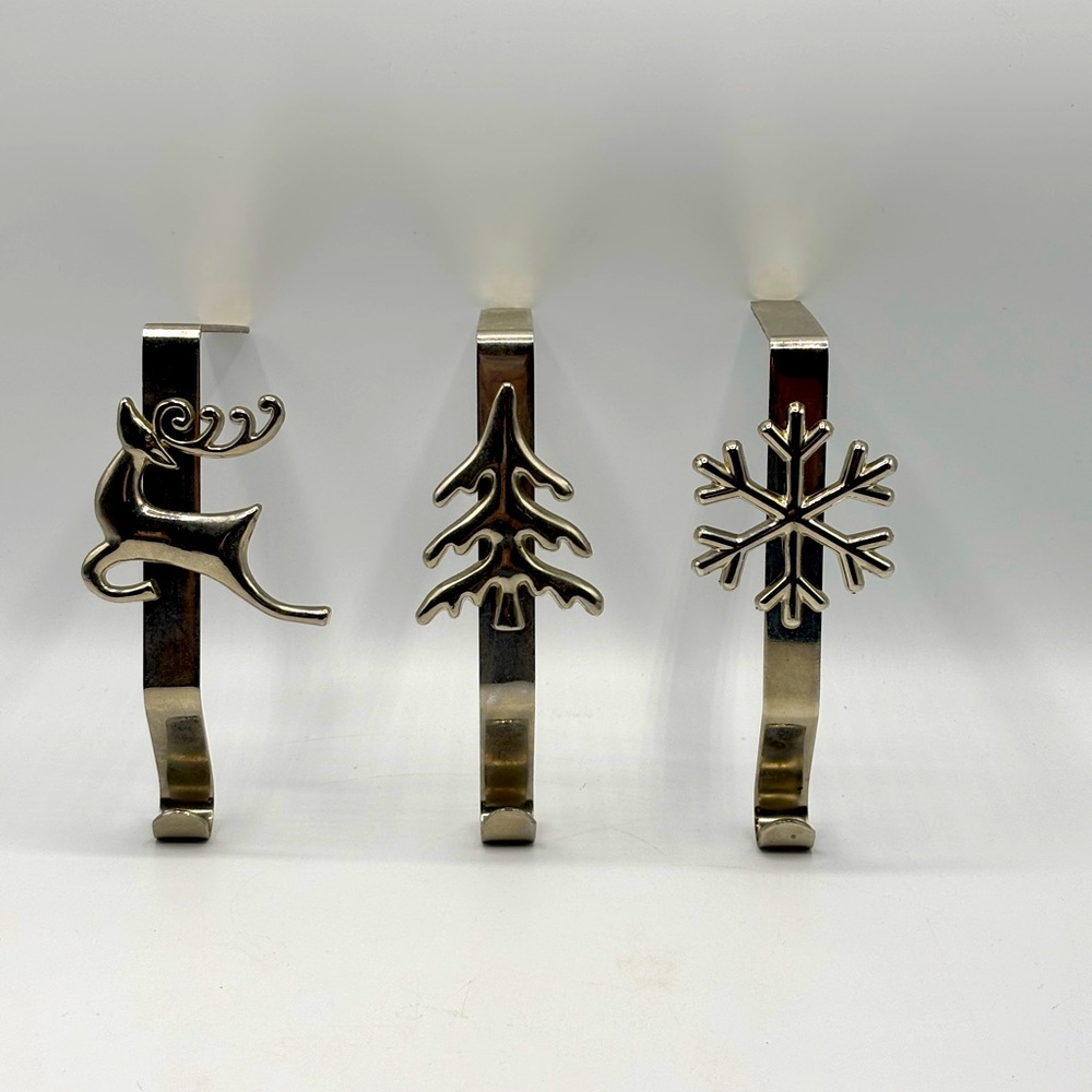 Silver metal stocking hangers. Reindeer, snowflake, tree.